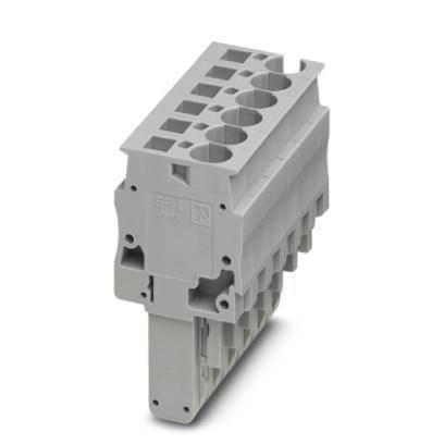 Boîtier de connecteur gris-gris avec plusieurs ouvertures de connexion et marqué d'un symbole.