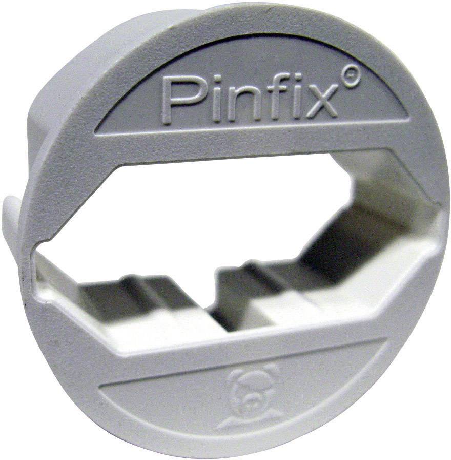 Un cache-fiche rond portant l'inscription 'Pinfix', qui protège les prises électriques contre tout accès non autorisé.