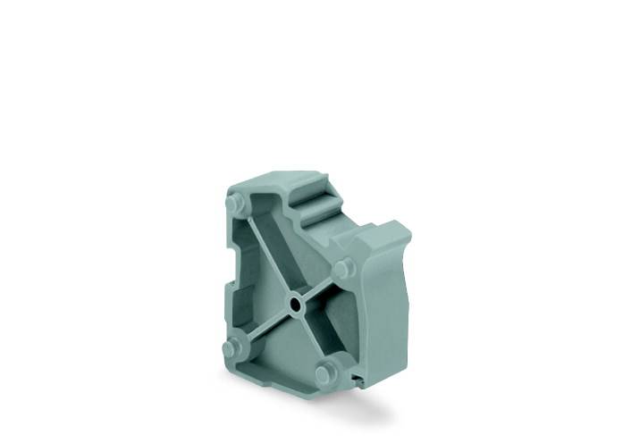 Une pièce en plastique grise avec des éléments saillants et un trou au centre, ressemblant à une unité de connexion géométrique.