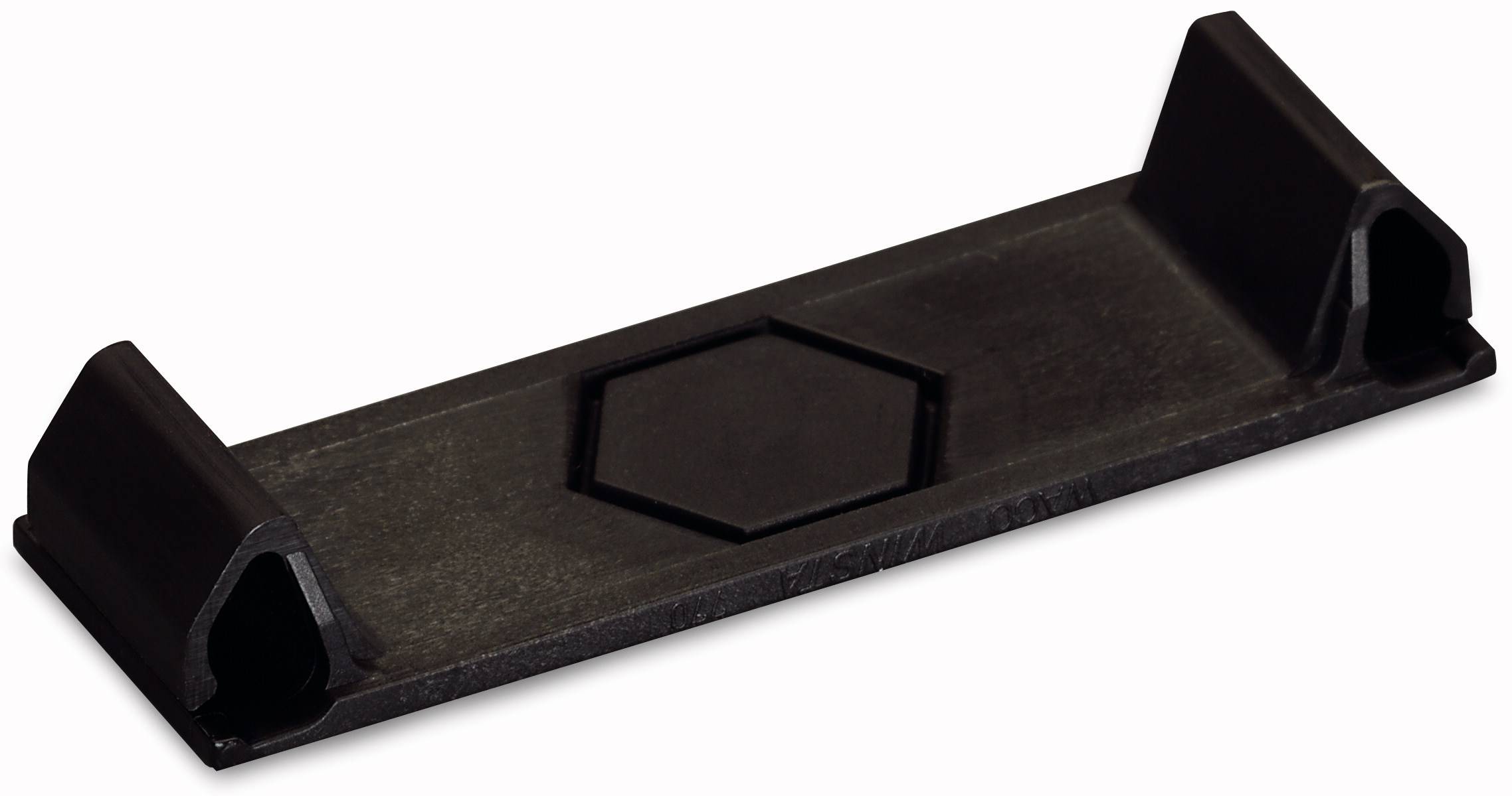 Un élément en plastique noir rectangulaire, probablement un socle de montage, avec un évidement hexagonal au centre.