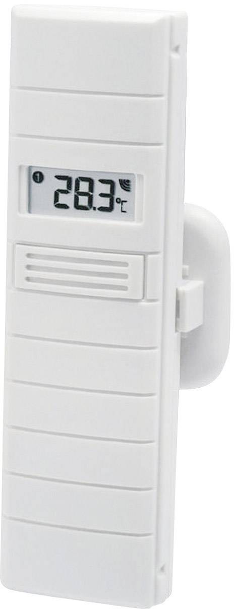 Un thermomètre numérique affiche une température de 28,3°C. Il est monté dans un boîtier blanc et est accroché au mur.