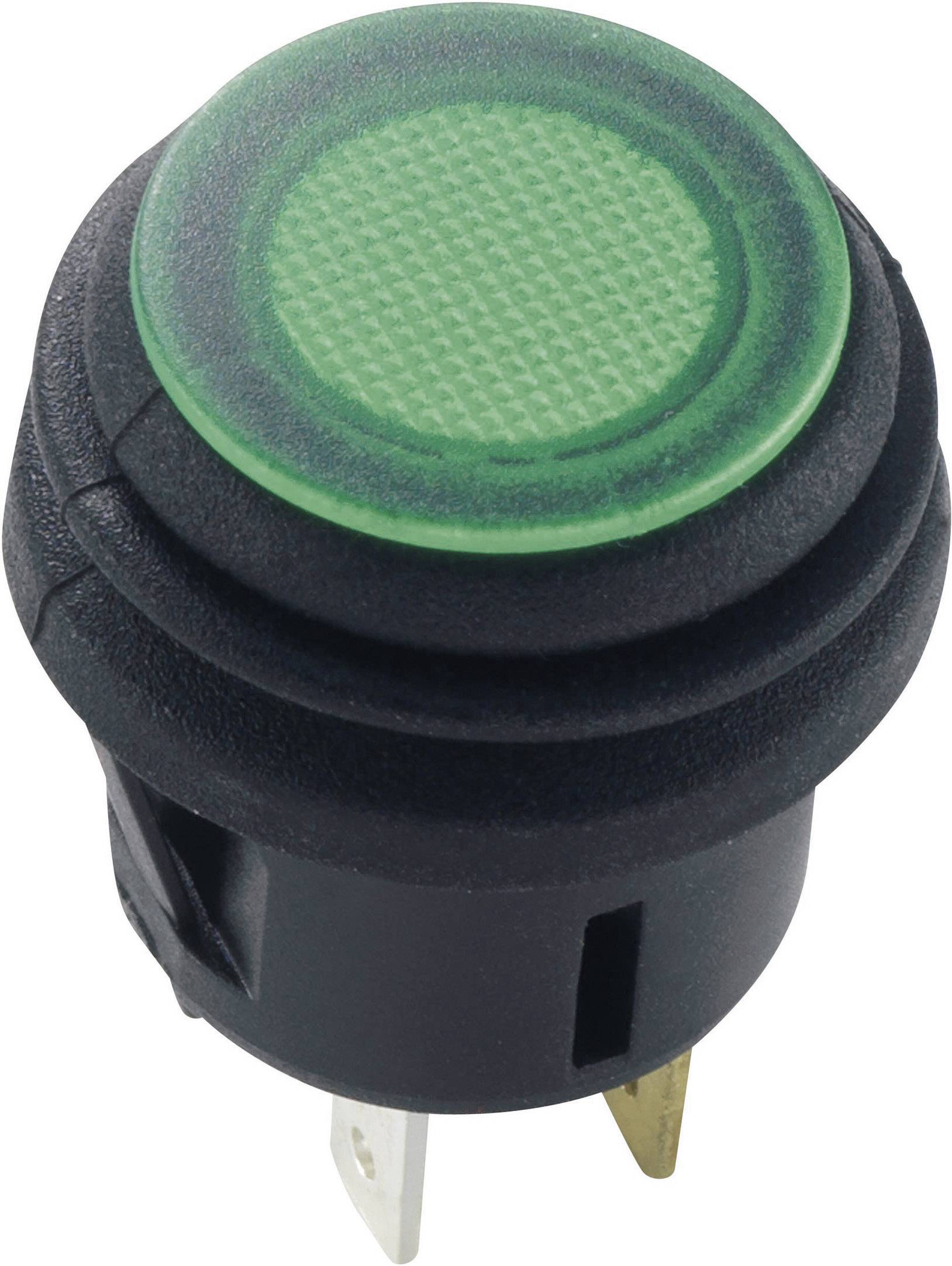 Interrupteur noir et rond avec un bouton-poussoir vert illuminé. L'interrupteur possède deux broches métalliques à sa base.