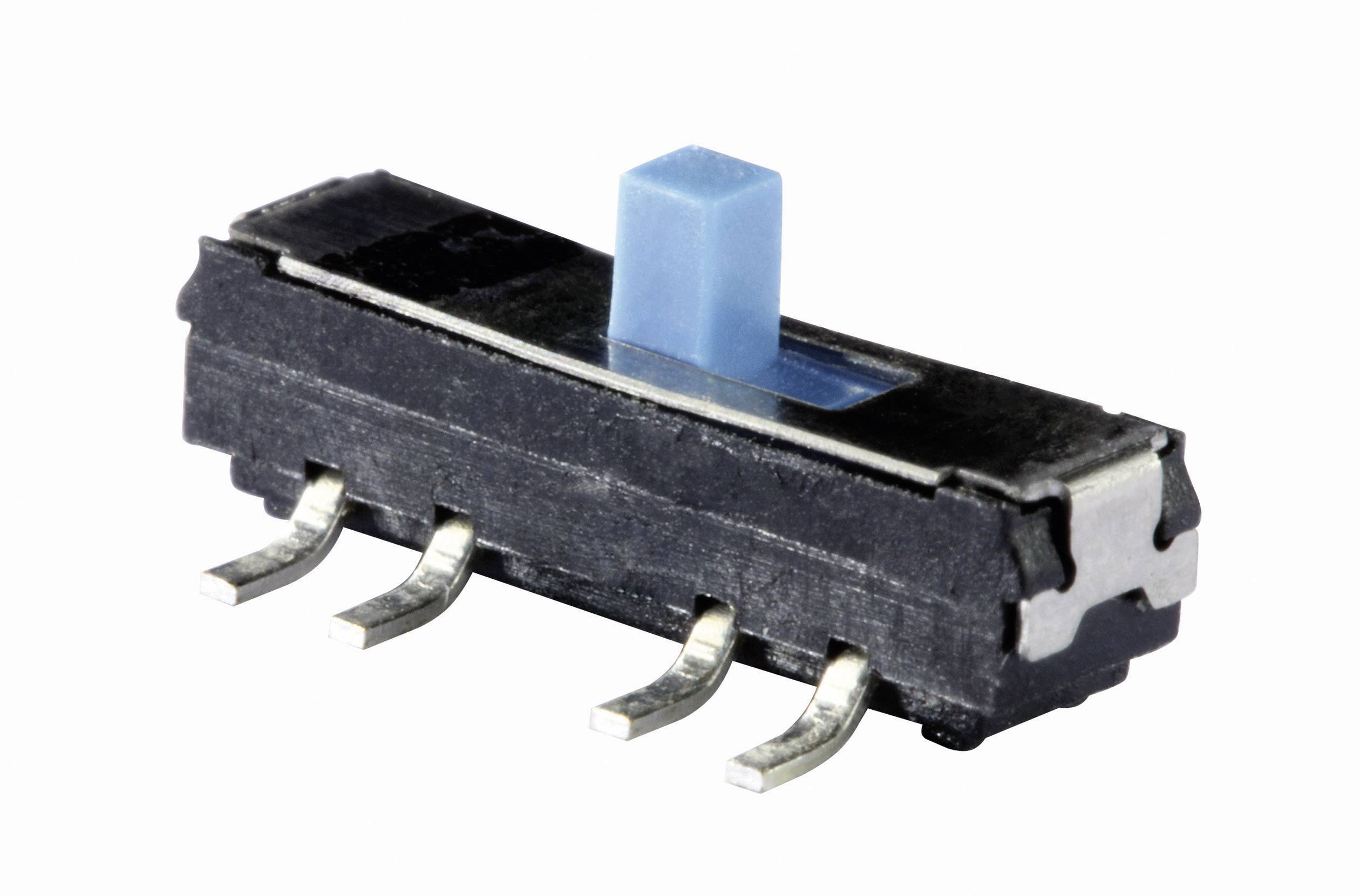 Un interrupteur coulissant bleu sur une surface blanche. L'interrupteur possède quatre broches pour la connexion à une carte de circuit imprimé.