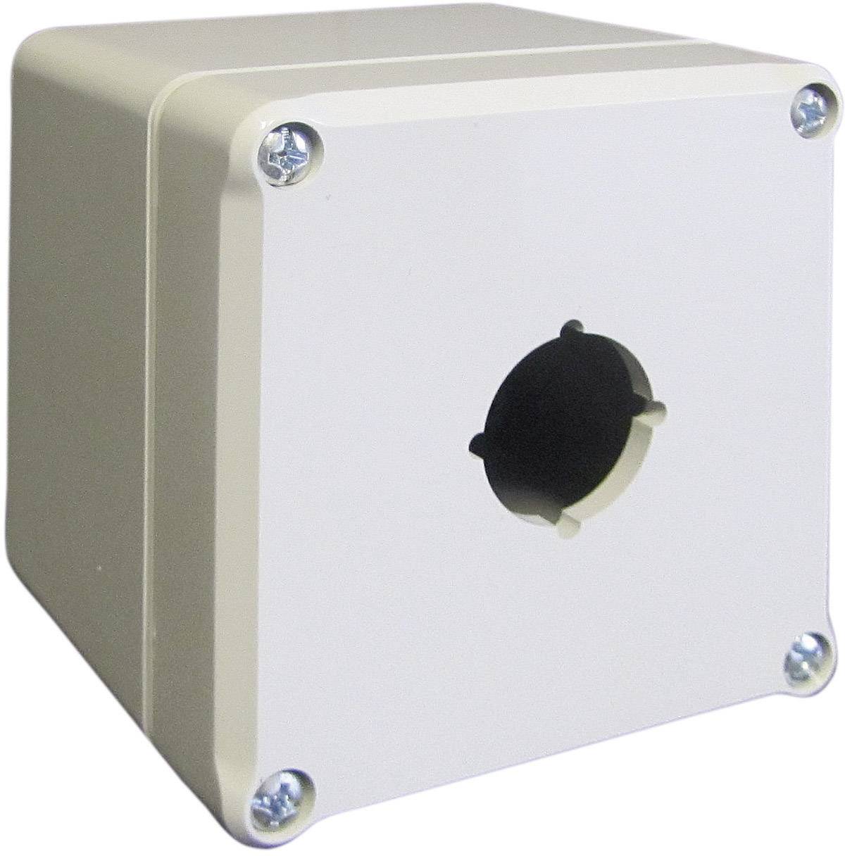 Un boîtier rectangulaire beige avec une ouverture circulaire au centre de la face avant.