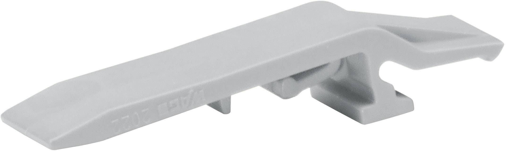 Un coin en plastique gris, probablement un élément d'un système de nivellement de carrelage, avec une pointe plate et biseautée et une structure de support à l'extrémité inférieure.