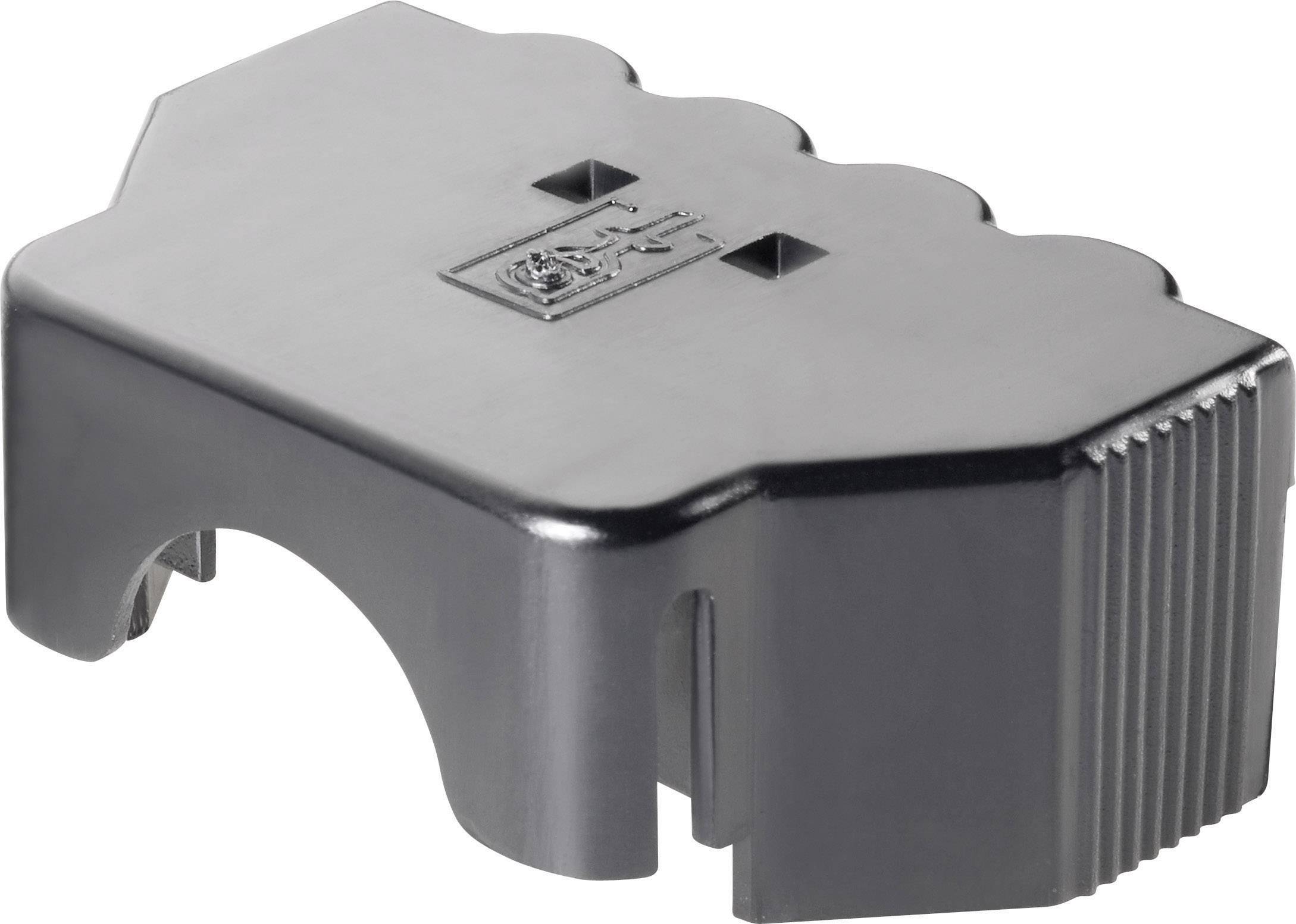 Un bloc de plastique noir rectangulaire avec un bord dentelé et deux ouvertures rectangulaires au centre.