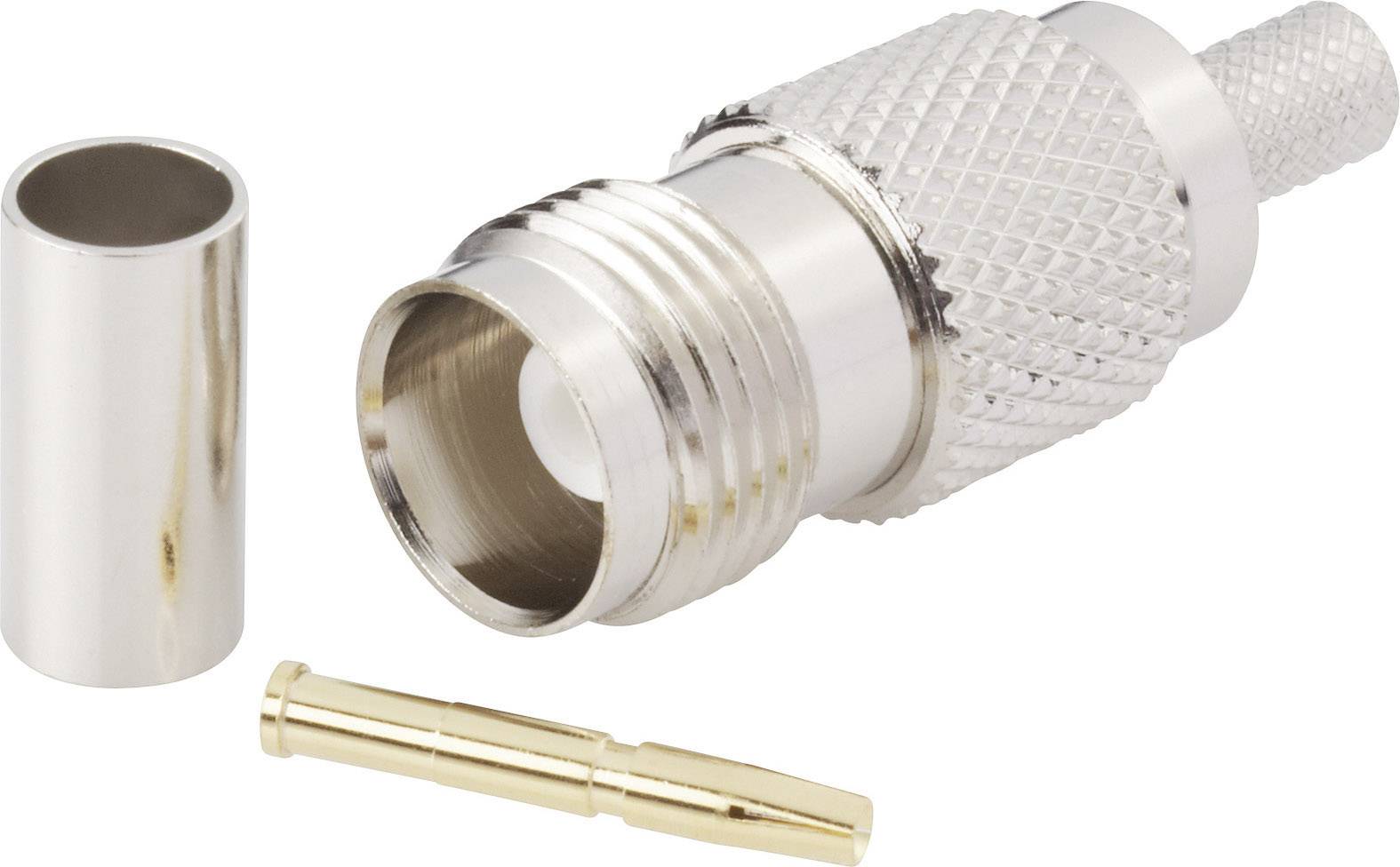 Éléments de connexion : une fiche métallique cannelée, une broche de contact dorée et un capuchon de protection métallique cylindrique.