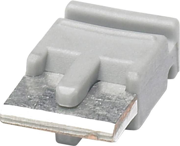 Un condensateur SMD électrique gris rectangulaire sur un fond blanc, montrant sa base métallique plate avec deux contacts.