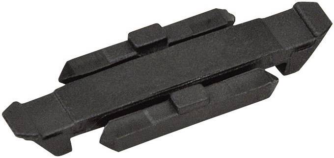 Un élément en plastique noir, rectangulaire, avec plusieurs arêtes surélevées et des creux, probablement un élément de connexion ou un entretoise.