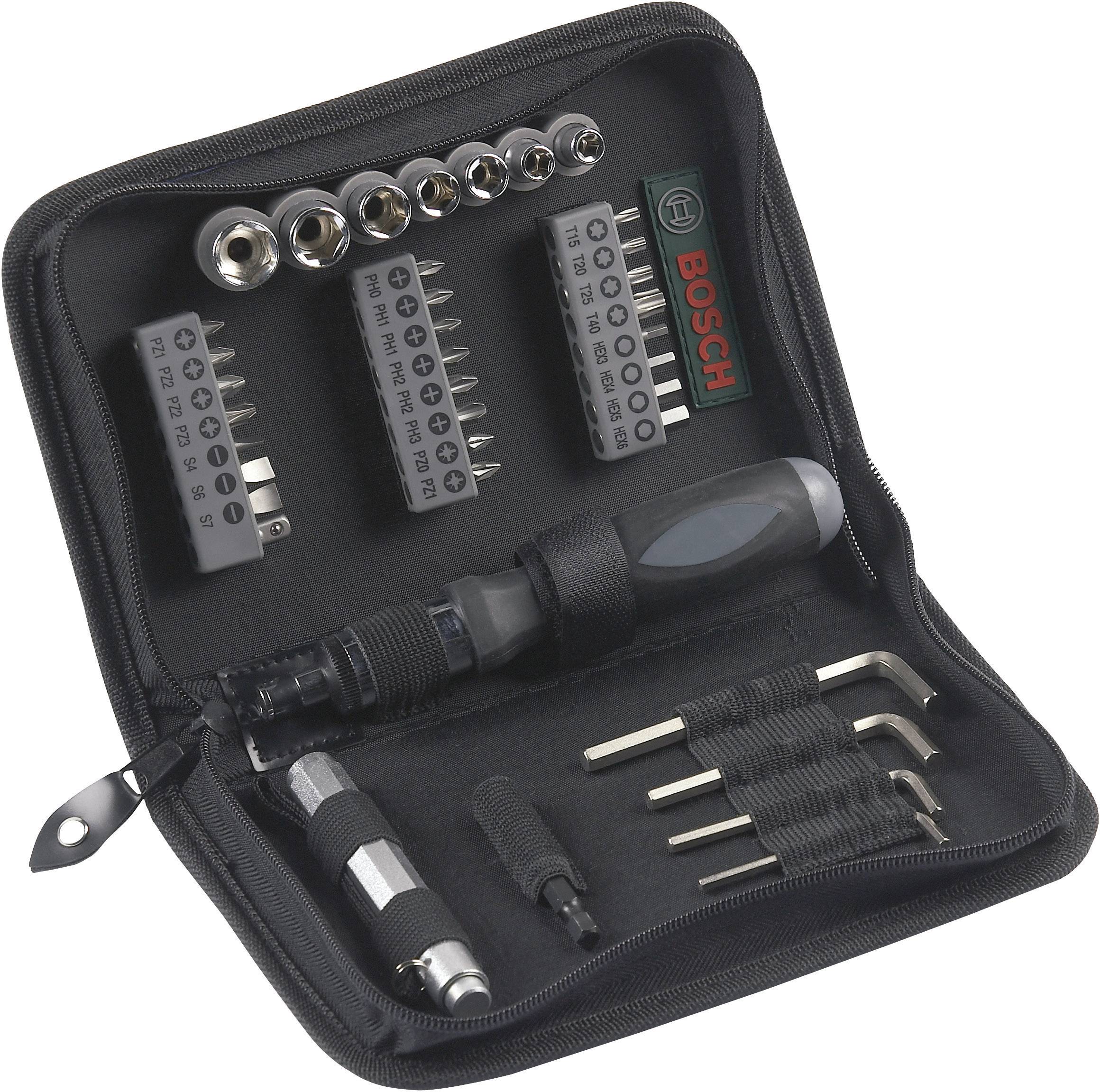Ensemble d'outils dans un sac noir, comprenant des embouts, un tournevis et des clés Allen. Le nom de marque 'Bosch' est visible.